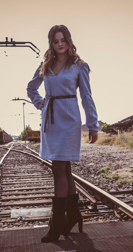 Vestido azul claro de manga larga, con escote en uve y capucha.